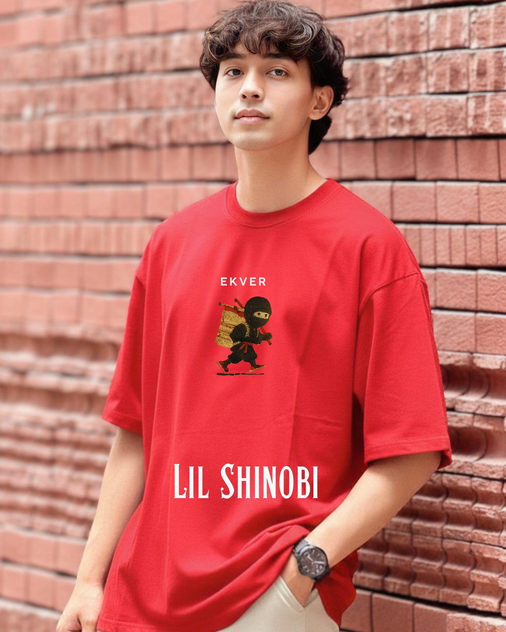 Person wearing a red t-shirt with 'LIL SHINOBI' design and 'EKVER' branding against a brick wall.